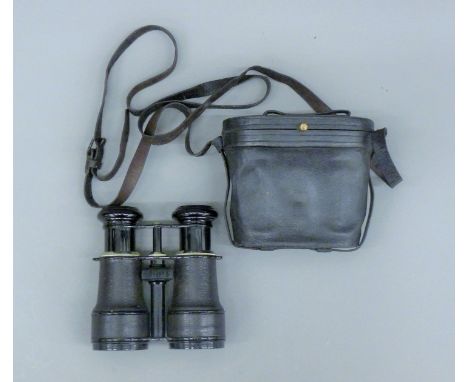 A pair of French field glasses with inset compass, cased. 13.5 cm wide overall.This lot is illustrated in the book Crimean Me