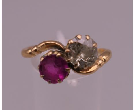 An antique 18 ct gold ruby and diamond crossover ring. Ring size U. 4.2 grammes total weight.