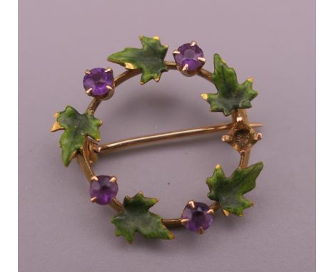 A small Continental 14 ct gold amethyst and enamel leaf wreath brooch. 2 cm diameter.