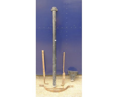 A quantity of metal brackets and a Victorian drain pipe.