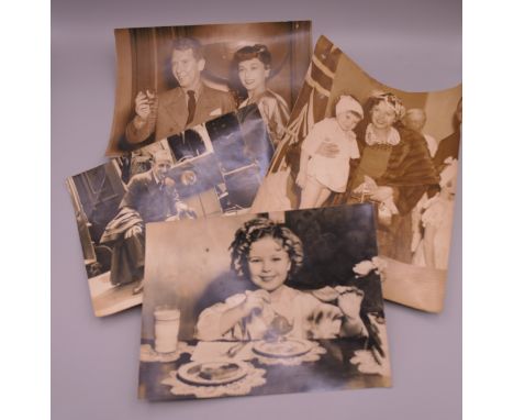 Four vintage photographs of various film stars, etc., including Paulette Goddard and Burguss Marmeredith, Shirley Temple at B