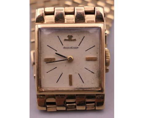 A 9 ct gold Jaeger LeCoultre ladies wristwatch. 1.75 cm wide. 29.4 grammes total weight.