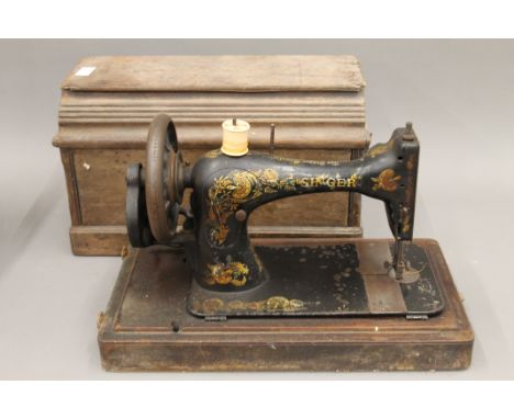 A vintage sewing machine, a vintage typewriter and a vintage mantle clock. 