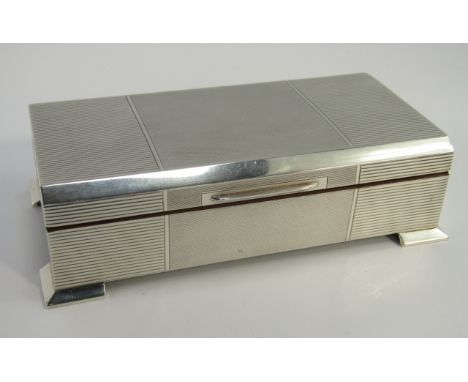 A silver Art Deco twin division cigarette box, with engine turned decoration, raised on bracket feet, Walker & Hall, Birmingh