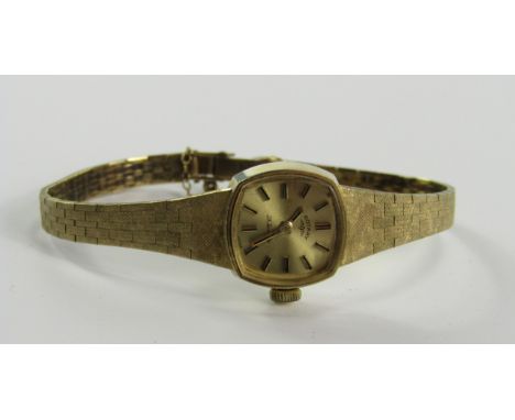 A Rotary lady's 9ct gold cased wristwatch, square dial bearing batons, 21 jewel movement, on a textured gold bracelet with sa