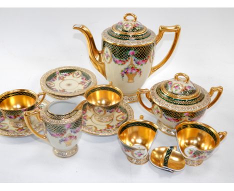 A Hutschenreuther porcelain part coffee service, early 20thC, painted with swags and baskets of flowers against a green and g