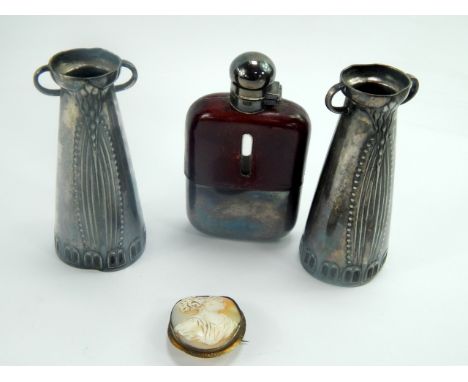 A pair of Jugendstil white metal vases, (AF), 11cm high, together with a leather bound plated hip flask and a cameo brooch bu