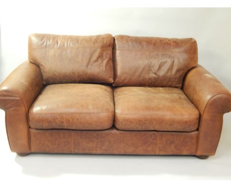  * A brown leather sofa, 180cm wide