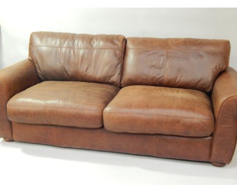  * A brown leather sofa, 215cm wide