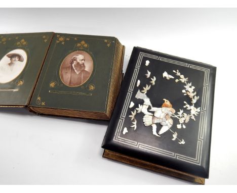 A Chinse lacquer bound photograph album, overlaid to cover in mother of pearl with an eagle in a tree, and a Victorian black 