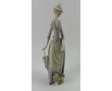 A Lladro porecelain figure of a lady, with a parasol and Pekingese dog, 35.5cm high.
