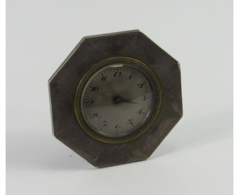 An Art Deco white metal cased octagonal strut clock, with engine turned sunburst decoration, silvered dial bearing Arabic num