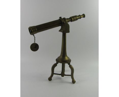 A brass telescope, on an integral tripod stand, 48cm high.