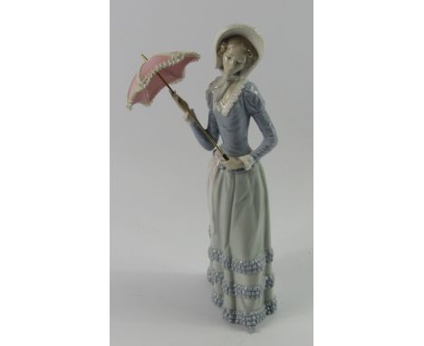 A Lladro porcelain figure of a lady, with an open parasol, 32cm high.