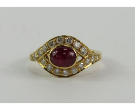 A yellow metal cabouchon ruby and diamond ring, in a cross over design, approx 0.6cts, size K, 4.5g