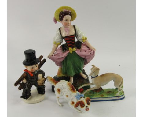 A Hummel figure of a boy with ladder, two 19thC ceramic figures of dogs and a Continental pottery figure of a girl, 24cm high