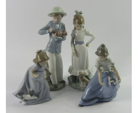 A Lladro Nao porcelain figure of a boy, holding a puppy, and three figures of girls with puppies, (4). 