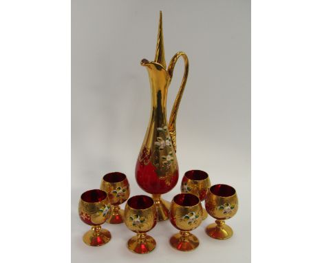 A Bohemian ruby glass liqueur set, of baluster form with gilt overlay and enamel floral decoration, comprising decanter and s