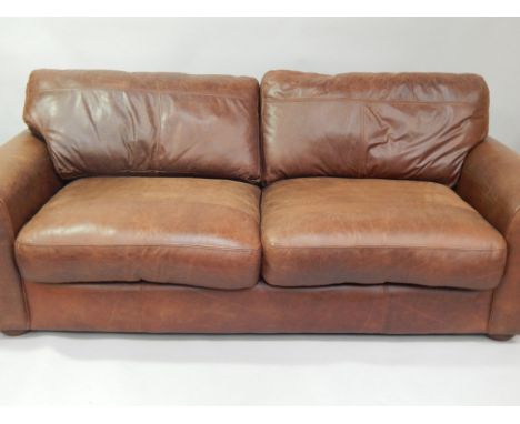  * A brown leather sofa, 215cm wide