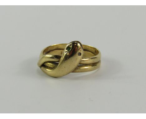 A yellow metal and gem set serpent ring, in a cross over design, stamped 18ct, size K, 3.8g