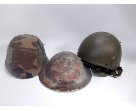 A Cogebi No 1 helmet, circa 1971, with camouflage fabric, a tin helmet and a galvanised helmet, (3).