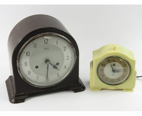 A Smiths cream Bakelite enamel alarm clock, 200/250v, together with a Smiths Enfield brown Bakelite mantel clock, silvered di