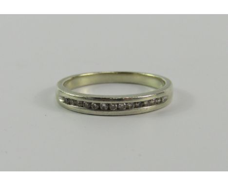 A white metal and diamond half hoop eternity ring, stamped 9ct, size K, 2.0g