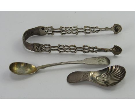 A George III silver scallop shell caddy spoon, with bright cut engraving, a pair of sugar tongs and a mustard spoon, 1.45t oz