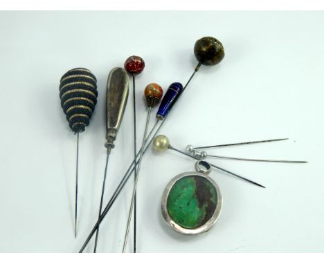 Victorian and later hat pins, including one set with an agate ball and two set with glass, together with a jade set white met