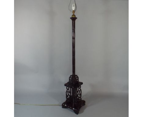 An Oriental Turned Standard Lamp with Carved Pierced Decorative Panels, The Support in Faux Bamboo Style. Square Base and Bra