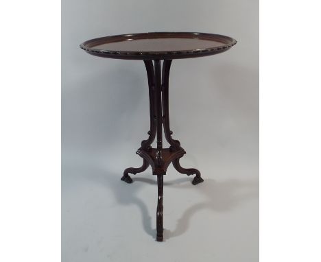 A Pretty 19th Century Mahogany Dish Top Tripod Wine Table with Wavy Rim. On Carved Moulded and Scrolled Supports. 51cm Diamet