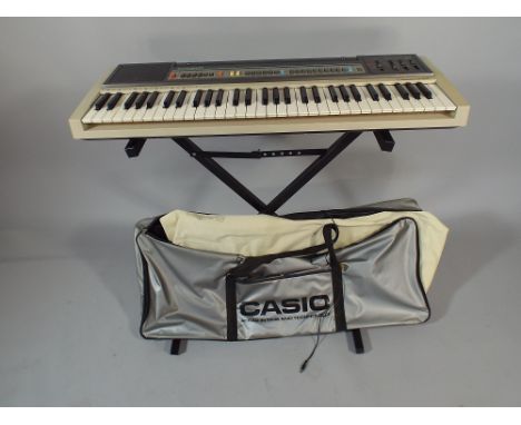 A Vintage Casiotone CT-605 Keyboard with Stand and Carrying Case. 