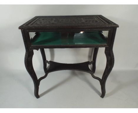 A Lift Top Carved Colonial Ebonised Bijouterie Table On Cabriole Supports with Stretcher Shelf. 77x49x82cm High.