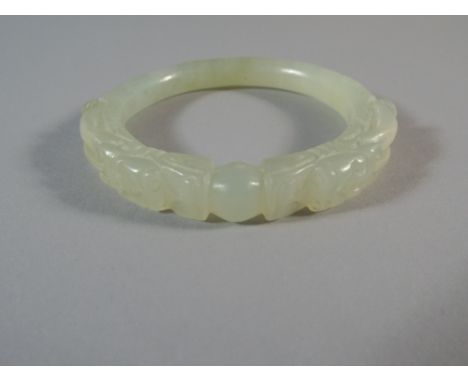 A Jade Bangle with Pierced and Carved Dragon Heads Decoration. 