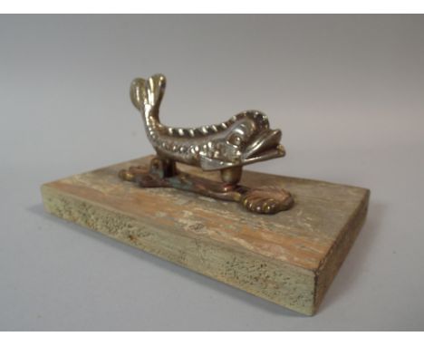 A 19th Century Cast Metal Door Knocker Modelled as A Stylized Dolphin, 13 x 8 Cm.