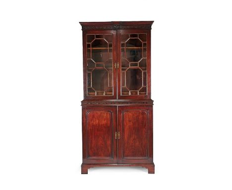 A George III mahogany secretaire bookcase
The ogee moulded cornice above a blind fret carved frieze and a pair of astragal gl