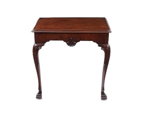 A George III Irish carved mahogany console tableThe rectangular moulded edge top above a shaped frieze centred by a shell, on