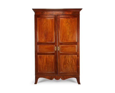 A George III Channel Islands mahogany wardrobe by Thomas Bishop
Inlaid with boxwood lines, the rectangular cavetto moulded co