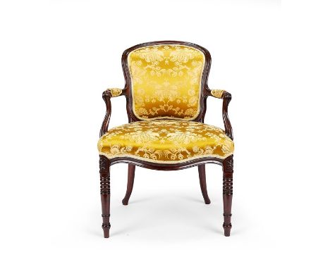 A George III carved mahogany armchair
in the French Hepplewhite taste
The cartouche shaped padded back, scroll arms and serpe