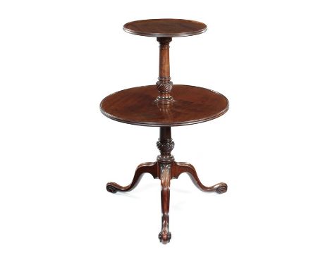 A George III carved mahogany two-tier dumb-waiter
in the manner of Thomas Chippendale
The circular moulded tops above ring tu
