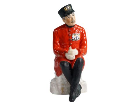 Produced by Coalport as part of the London Heritage series, this porcelain figurine depicts a Chelsea Pensioner seated on a s