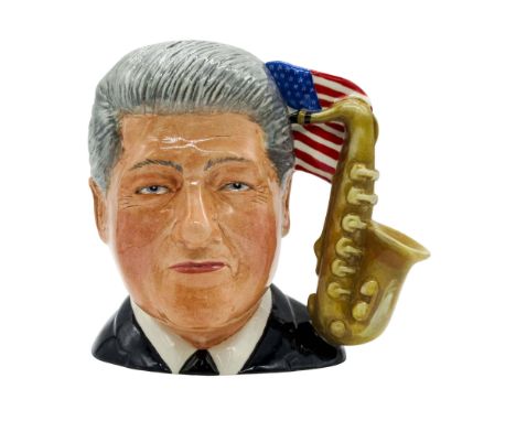 Prototype ceramic molded figure of the 42nd president of the United States; saxophone and American flag handle. Royal Doulton