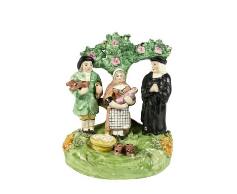 Hand painted and hand decorated Mid-Late Victorian Staffordshire Tithe Pig Group figure, which historically refers to the pig