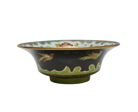 The exterior is decorated with a stark black ground, contrasting with vibrantly enameled birds in flight, painted in red, blu