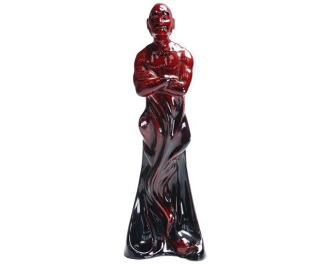 This dramatic Royal Doulton Flambe figurine titled The Genie HN2999 portrays a powerful mythological figure standing with arm