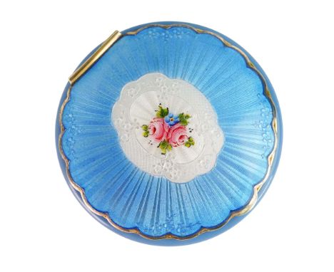 A charming vintage blue guilloche compact, featuring a beautifully intricate design on its exterior, complemented by a luxuri