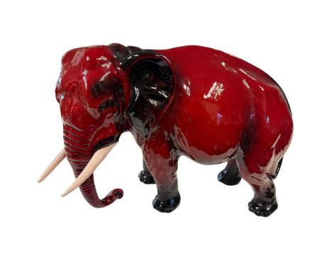 This magnificent flambe figure features a large elephant with its trunk gracefully down, showcasing the brands mastery of scu