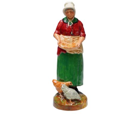 Crafted by Royal Doulton, The Farmer's Wife HN2069 captures the pastoral charm of a countryside matron tending to her chicken