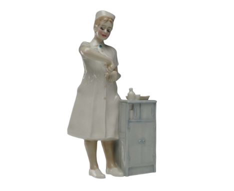 Rare Royal Doulton hand-painted prototype porcelain figurine depicting a nurse at work beside a medical cabinet. The nurse is