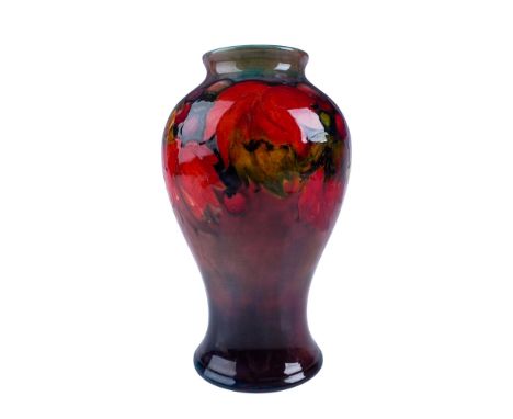 An exquisite Moorcroft flambe vase showcasing the elegant Leaf and Berry pattern. This stunning piece is hand decorated with 
